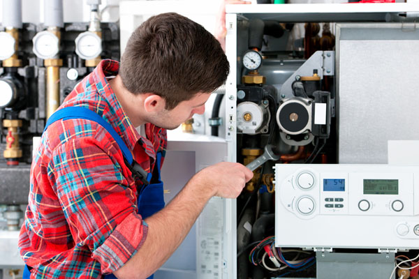 Heating technician repairing boiler controls in Rohnert Park
