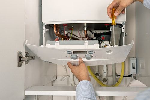 Heating technician repairing a residential boiler in Rohnert Park
