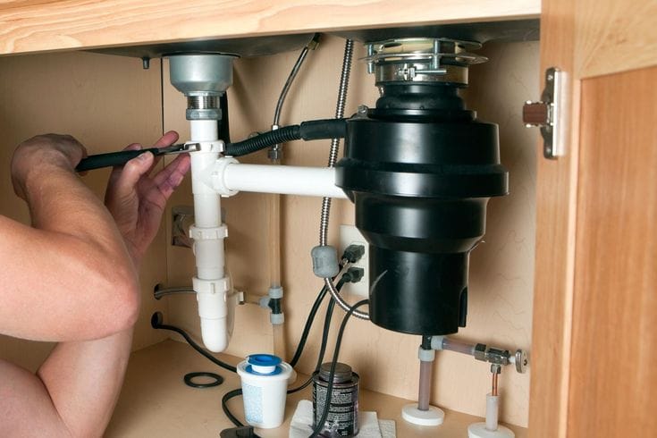Plumber repairing a garbage disposal in Rohnert Park