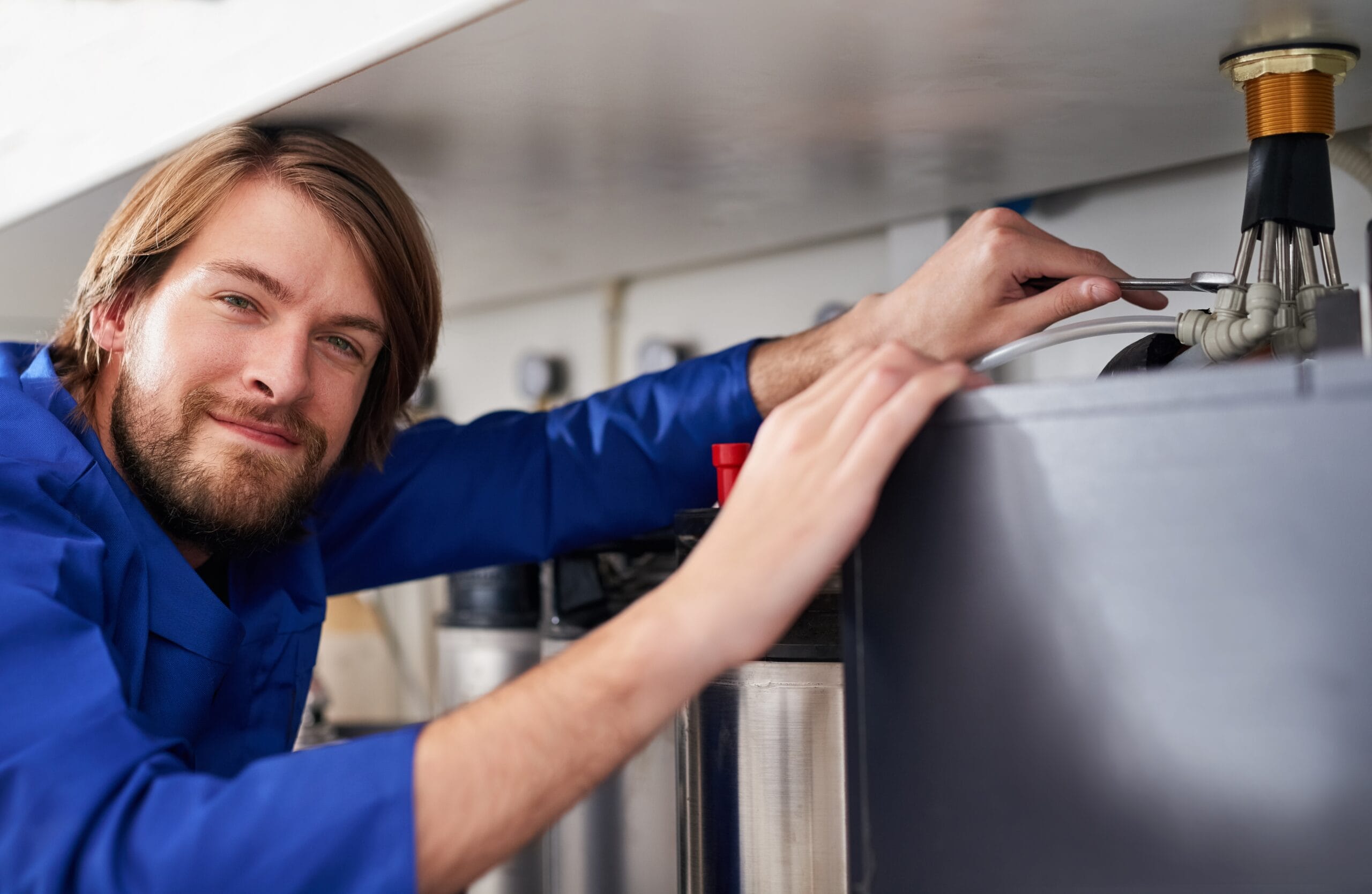 Technician servicing a residential water heater tank in Rohnert Park